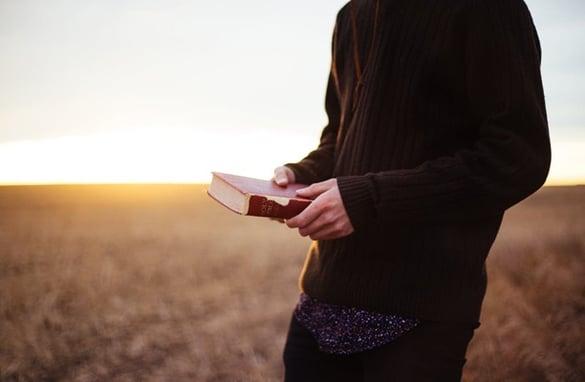 Man Holding Worn Bible | Pure Flix