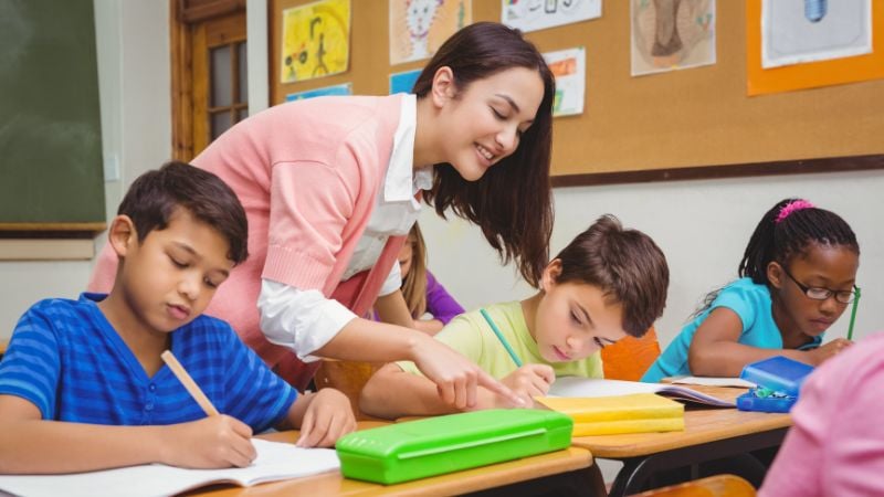 teacher helping student with back to school