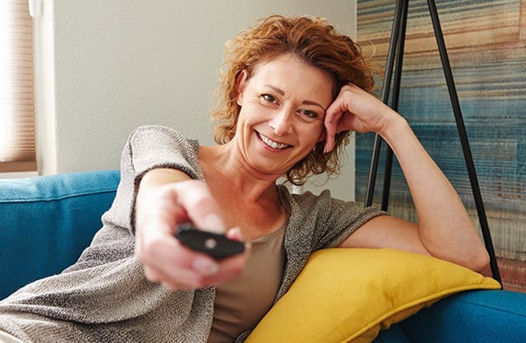 Woman Watching TV with Fire Stick | Pure Flix Woman Watching TV with Fire Stick | Pure Flix