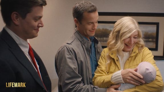 mother and father holding adopted baby