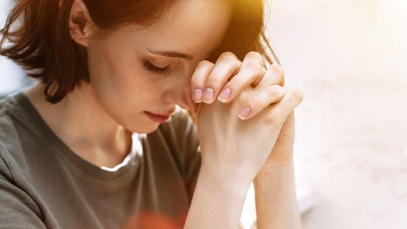 woman saying daily prayers