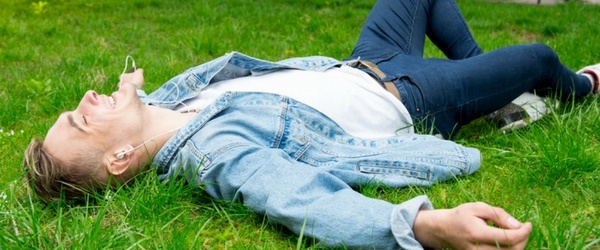 Young Man Listening to Music in a Field - Pure Flix