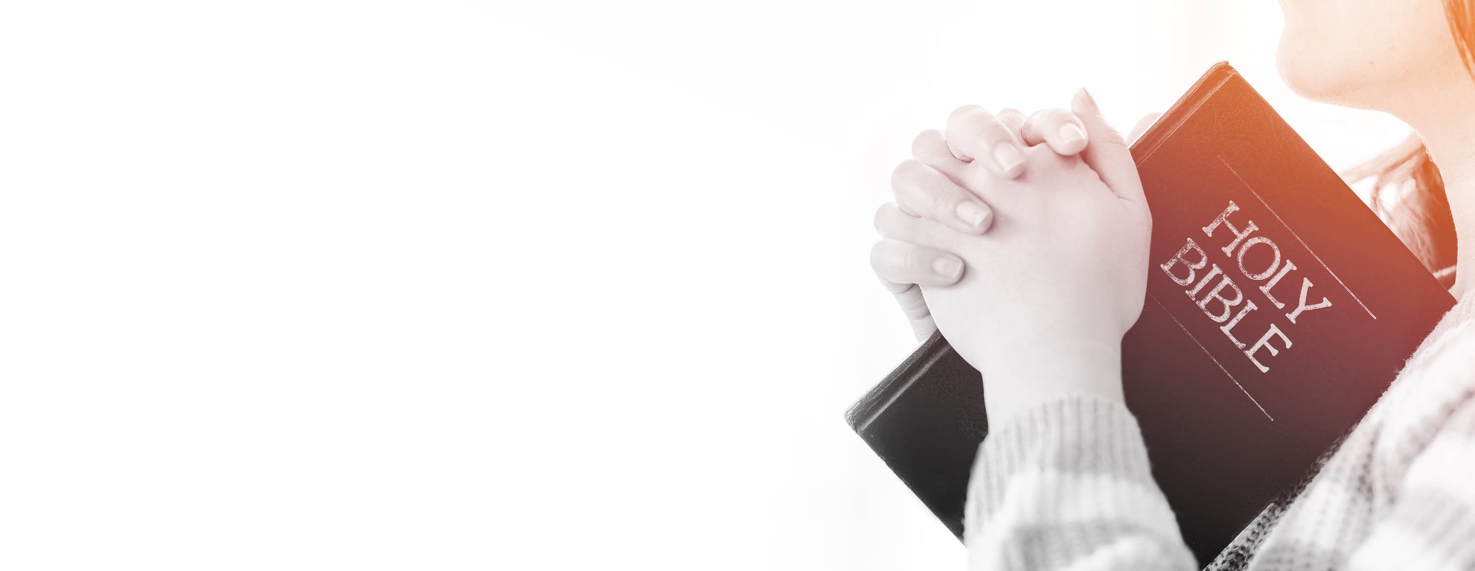 praying hands with bible