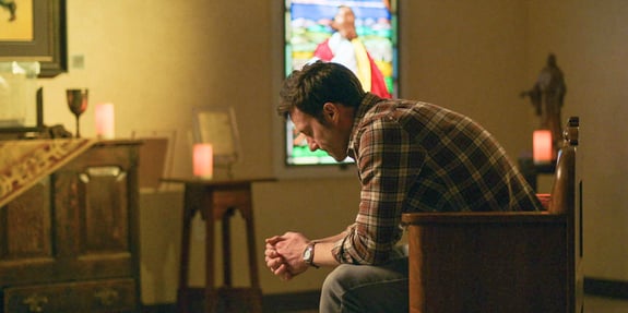 man praying in chapel divine influencer
