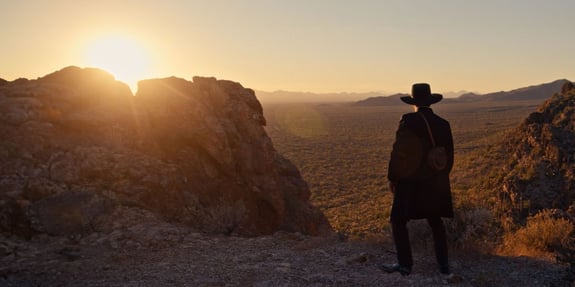 lucas black staring into desert valley at sunset birthright outlaw