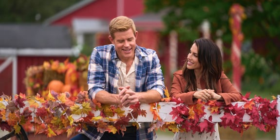 trevor donovan jessica lowndes leaning on fence a harvest homecoming