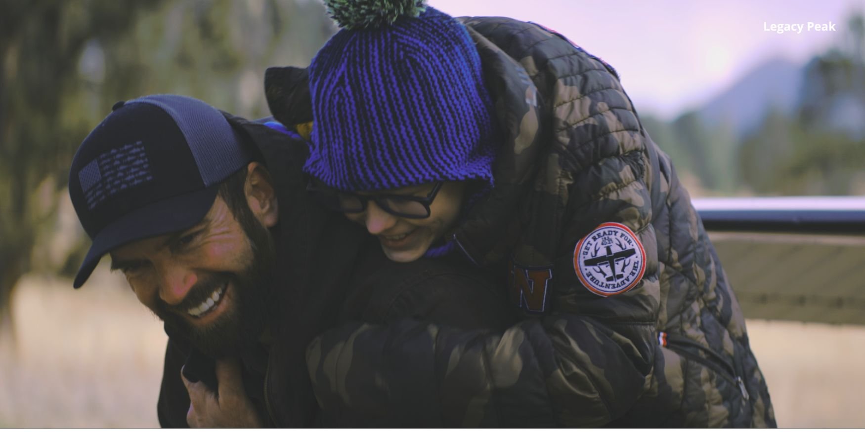 legacy peak lucas black fatherhood hug from behind